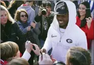  ?? ASSOCIATED PRESS FILE PHOTO ?? Georgia linebacker Nakobe Dean is greeted by a large crowd of fans as he and his teammates return to the Georgia campus earlier this month in Athens, Ga.