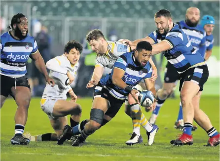  ?? PICTURES: David Rogers/getty Images ?? Bath’s Taulupe Faletau as he is tackled by Thomas Young to set up a try during the defeat on Friday