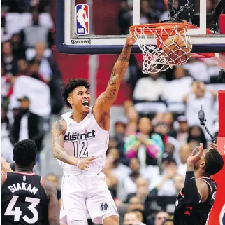  ?? PHOTOS: NICK WASS/THE ASSOCIATED PRESS ?? Forward Kelly Oubre Jr. dunks as the Washington Wizards earned their first win of the series Friday on home court, downing the Toronto Raptors 122-103 in Game 3.