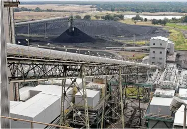  ?? Associated Press file ?? Coal is transporte­d up a conveyor belt into the TXU Corp’s Big Brown coal-fired power plant near Fairfield in East Texas. The electric station was the first large-scale, lignite-fueled power plant of the modern era for TXU. Its parent company, Vistra...