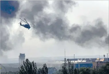  ?? Photo: REUTERS ?? Gunfight: A Ukrainian helicopter Mi-24 gunship fires its cannon against rebels at the main terminal building of Donetsk internatio­nal airport.