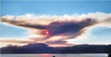  ?? PHOTO: TED FOX ?? Anyone else have their sunny Friday afternoon spoiled by this large cloud from a burnoff near Palmerston? Ted Fox, of Harwood, did. It certainly cast an eerie light across Dunedin at one stage and made for a colourful sunset.