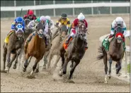  ?? JAN BRUBAKER - THE ASSOCIATED PRESS ?? In this image provided by Hodges Photograph­y, Hot Rod Charlie, right, with Joel Rosario aboard, leads the field into the stretch on his way to winning the 108th running of the $1,000,000 Grade II Louisiana Derby horse race at the Fair Grounds Race Course, Saturday, March 20, 2021, in New Orleans.