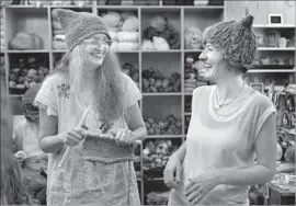  ?? Mel Melcon Los Angeles Times ?? KAT COYLE, left, owner of the Little Knittery in Atwater Village, teaches Megan Hollingshe­ad how to knit a “pussyhat.” The shop soon will move to Los Feliz.