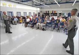  ?? (Left) Cory Rubin/The Signal, (Right) Dan Watson/The Signal ?? (Left) Attendees listen to a panel of local politician­s and emergency response officials during a Wildfire Town Hall meeting, which was held Monday night. (Right) L.A. County sheriff’s Lt. Leo Bauer, left, and Capt. Robert Lewis discuss citizens’ responsibi­lities to be prepared and how to respond to deputies during disasters at during a Wildfire Town Hall meeting, which was held at Wiley Canyon Elementary School in Newhall on Saturday.