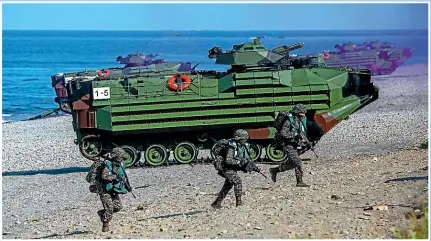  ?? GETTY IMAGES ?? Taiwanese soldiers simulate a Chinese invasion during exercises last month. There are only about a dozen beaches suitable for a large-scale invasion and Taiwan has spent decades building defences on them.
