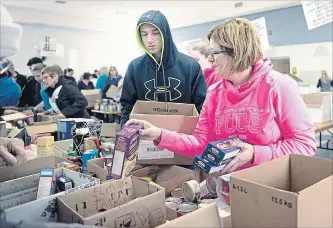  ?? METROLAND FILE PHOTO ?? It takes a small army of volunteers to get 13,500 kilograms of food picked up, dropped off and sorted at Christian Life Assembly and delivered to Port Cares.