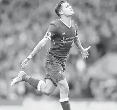  ??  ?? Liverpool’s Coutinho celebrates scoring the second goal during the English Premier League match against Middlesbro­ugh at Anfield in this May 21 file photo. — Reuters photo