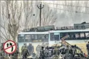  ?? PTI FILE ?? Security personnel at the site of the suicide bomb attack in
Pulwama on February 14, 2019.