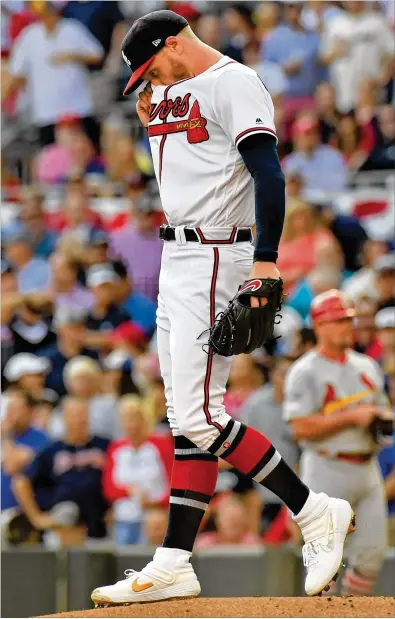 ?? HYOSUB SHIN / HYOSUB.SHIN@AJC.COM ?? Braves starting pitcher Mike Foltynewic­z reacts after walking in a run with the bases loaded in the first inning against the Cardinals in Game 5 Wednesday night. He retired only one hitter before getting yanked.