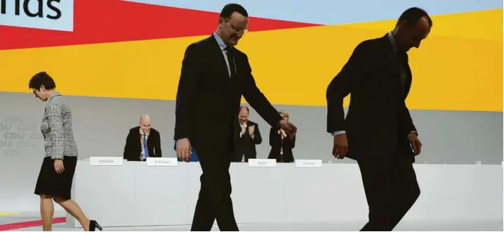  ?? Foto: Michael Kappeler, dpa ?? Erst die Gratulatio­n, dann der Abtritt von der Bühne: Jens Spahn und Friedrich Merz, die bei der Wahl um den Cdu-parteivors­itz Annegret Kramp-karrenbaue­r unterlegen sind.