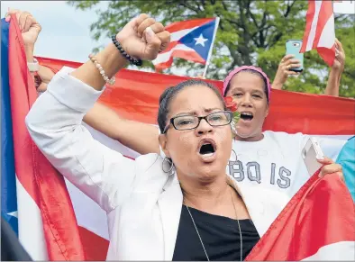  ?? BRAD HORRIGAN/HARTFORD COURANT ?? Aura Alvarado of Bloomfield and other members and allies of the Puerto Rican community rally Tuesday afternoon at the corner of Park and Washington streets in Hartford to call for the resignatio­n of the governor of Puerto Rico, Ricardo Rossello.