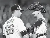  ?? GAIL BURTON/AP ?? Baltimore Orioles' Tanner Scott, left, and Caleb Joseph talk on the mound against the Athletics last week.