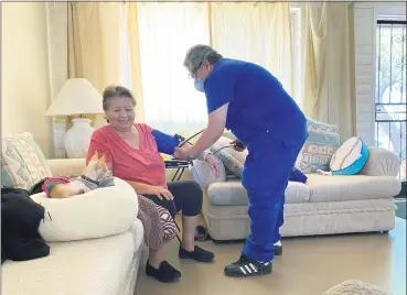  ?? SHANNON TODECHEENE VIA AP ?? Carol Todecheene, left, receives therapy services May 15, at the home of her daughter in Tucson, Ariz. Carol Todecheene was among those severely hit with the coronaviru­s.