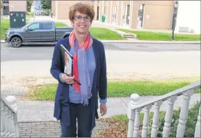  ?? KATHERINE HUNT/THE GUARDIAN ?? Kim Devine walks up the stairs of a downtown Charlottet­own residence while on the mayoral campaign trail Saturday.