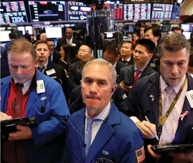  ?? (Brendan McDermid/Reuters) ?? TRADERS WORK on the floor of the New York Stock Exchange last week. On Friday, both the Dow Jones Industrial Average and S&P 500 index closed out their worst two-week performanc­e since August 2011.