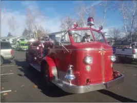  ??  ?? Robert Fickert drives his 1948 American LaFrance 700 Series fire engine as part of the 25th annual Chico Firefighte­r’s Associatio­n’s Adopt-A-Family Christmas Gift and Food Basket Delivery Day on Saturday in Chico. The city of Chico originally had just four and there is now just one left. The engine was a reserve engine until 1995 and has been in all 25 years Adopt-A-Family toy drives.