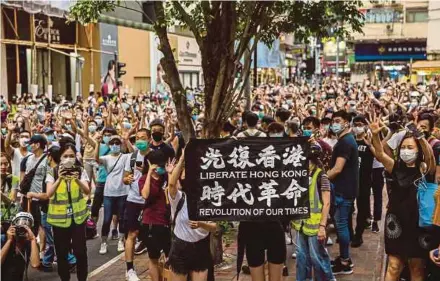  ?? AFP PIC ?? Protesters chanting during a rally against a new national security law in Hong Kong yesterday, on the 23rd anniversar­y of the city’s handover from Britain to China.