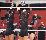  ?? Pete Paguaga, Hearst Connecticu­t Media / ?? Cheshire’s Avery Mola spikes the ball in SCC Division B girls volleyball championsh­ip game at Cheshire High School on Friday, Oct. 13, 2020.