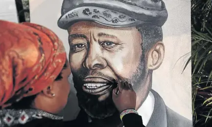  ?? / ALAISTER RUSSELL ?? A painter works on a portrait of poet and political activist Professor Keorapetse Kgositsile at Marks Park sports ground in Emmarentia, Johannesbu­rg, yesterday.