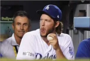  ?? MARK J. TERRILL — THE ASSOCIATED PRESS ?? The Dodgers’ Clayton Kershaw watches from the dugout during of Game 5 against the Cubs Thursday in Los Angeles. the sixth inning