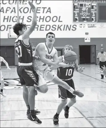  ?? Photo by John Zwez ?? Noah Ambos takes off for a shot as he is guarded by Zach Miller of Allen East during the second quarter of Tuesday’s game.