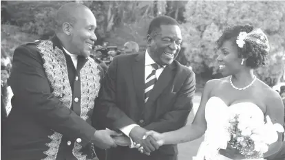  ??  ?? Vice-President Emmerson Mnangagwa congratula­tes Kudakwashe Mupamhanga and his sweetheart Katie Murray at their wedding which took place at Palm Eastate, Greystone Park, in Harare yesterday. The bridegroom is son to Deputy Chief Secretary to the President and Cabinet Mr Justin Mupamhanga