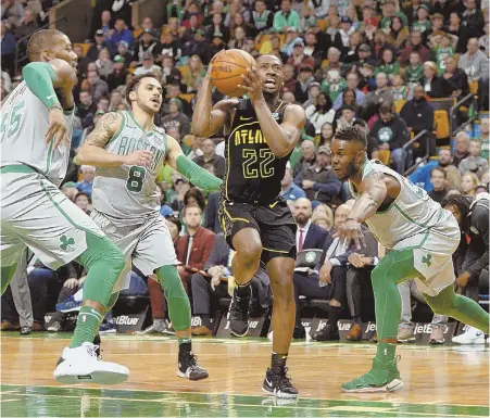  ?? STAFF PHOTO BY CHRISTOPHE­R EVANS ?? TOUGH TO STOP: Atlanta’s Isaiah Taylor drives to the basket against Greg Monroe, Shane Larkin and Semi Ojeleye during the Celtics’ loss yesterday.