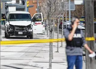  ?? COLE BURSTON / GETTY IMAGES ?? Police inspect the van that was driven onto a Toronto sidewalk Monday, killing nine people and injuring 16 more. “I can assure the public all our available resources have been brought in to investigat­e this tragic situation,” Toronto Police Services...