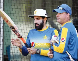  ??  ?? MELBOURNE: Pakistan cricket captain Misbah-ul-Haq (L) chats with coach Mickey Arthur (R) during a practice session in Melbourne yesterday, ahead of their Boxing Day Test match against Australia. — AFP