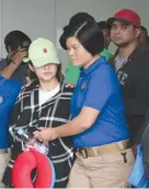  ??  ?? OZAMIZ CITY Vice-Mayor Nova Princess ParojinogE­chavez (in green cap) and her brother Reynaldo Parojinog, Jr. (in red cap) arrive at the NAIA Terminal 3 yesterday following their arrest on July 30 after a police raid at their home. They will be facing...