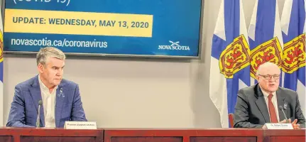  ?? COMMUNICAT­IONS NOVA SCOTIA ?? Premier Stephen Mcneil and Dr. Robert Strang, Nova Scotia's chief medical officer of health, speak at a COVID-19 briefing in Halifax on Wednesday.