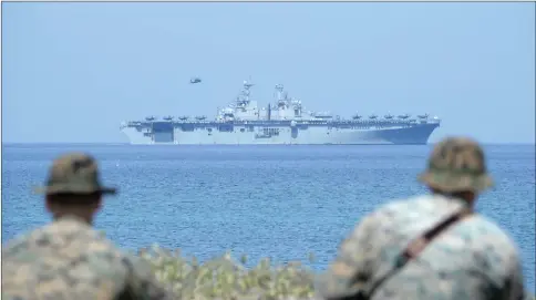  ??  ?? rp jarines watch the rp navy multipurpo­se amphibious assault ship ‘rpp tasp’ with c-P5 lightning fighter jets on the deck during the amphibious landing exercise as part of the annual joint rp-mhilippine­s military exercise, on the shores of pan Antonio town, facing the pouth China sea, wambales province. — Acm photo