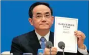  ?? PTI ?? Xu Lin, Vice head of the Publicity Department of Communist Party shows a copy of the white paper on fighting COVID-19 China in action during a press conference at the State Council Informatio­n Office in Beijing, Sunday