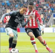  ?? Picture: GETTY IMAGES ?? GREAT FUTURE: Justin Kluivert, left, of Ajax Amsterdam holds off the challenge of Joshua Brenet of PSV Eindhoven during their Dutch Eredivisie match at the Phillips stadium in Eindhoven, The Netherland­s