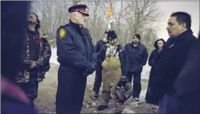  ?? PHOTOS: GEOFF ROBINS /THE CANADIAN PRESS ?? Sarnia police Chief Phil Nelson meets with Chief Chris Plain, right, of the Aamjiwnaan­g First Nation on Jan. 2, the last day of a native blockade of the CN Rail tracks in Sarnia, Ont.