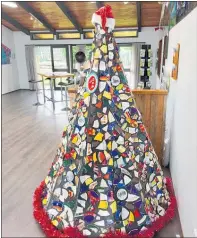  ??  ?? Nicky Austin and her family made this stunning upcycled tree from broken plates and cups — it’s on display at the Arts Junction.