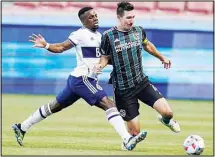  ?? (AP) ?? Vancouver Whitecaps forward Cristian Dajome, (left), defends against LA Galaxy midfielder Sacha Kljestan during the first half of an MLS soccer match, on July 17, in Sandy, Utah.