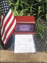  ?? MONICA SAGER — DIGITAL FIRST MEDIA ?? Someone from the community left this box in Edgewood Cemetery. Part of the note wishes the Flag Day event to go well.