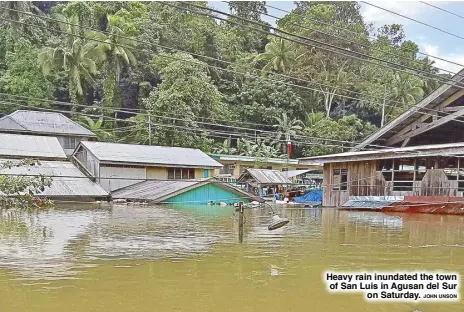  ?? JOHN UNSON ?? Heavy rain inundated the town of San Luis in Agusan del Sur on Saturday.