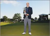  ??  ?? Jordan Spieth poses with the Travelers Championsh­ip trophy after Sunday’s final round in Cromwell, Conn.