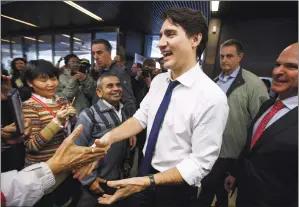 ?? CP PHOTO JASON FRANSON ?? Prime Minister Justin Trudeau meets with people at a Seniors Associatio­n in Edmonton on Thursday.