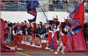  ?? GEORGE SPITERI — FOR MEDIANEWS GROUP ?? Christian Purchase carries the Cousino flag prior to a game against Eastpointe.