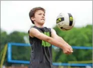  ?? THOMAS NASH — DIGITAL FIRST MEDIA ?? Evan Zettle, a 12-year-old from Norristown, hits a volley while playing a match at the Pottstown Rumble Volleyball Tournament on Saturday. Zettle played alongside his father, Eric Zettle.