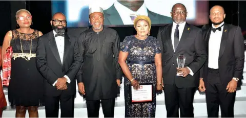  ?? The Sun ?? Head, Structured Trade Finance, First Bank of Nigeria Limited, Ikenna Egbukole; CEO, Dr. Adesola Adeduntan; His wife, Adenike Adeduntan; General Counsel, Firstbank and Subsidiari­es, Raymond Mgbeokwere; Executive Director, Treasury and Internatio­nal Banking, Ini Ebong; Head, Client Services, Funmi Akadiri at the presentati­on of the Banking Icon of the Decade award to Dr. Adeduntan at Awards held in Lagos… at the weekend.