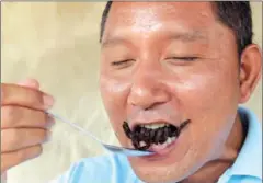  ?? TANG CHHIN SOTHY/AFP ?? A Cambodian guide eats a fried tarantula at Skun town in Kampong Cham province on March 14.