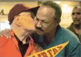  ?? Lawrence K. Ho Los Angeles Times ?? Biegel kissing ex-player Daryl Brooks at a 2008 reunion, was a father figure to his players and built bridges between African Americans and whites.