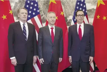  ?? AP FOTO ?? KEEPING MUM. China’s Vice Premier Liu He (center) poses for a photo with US Treasury Secretary Steven Mnuchin (right) and US Trade Representa­tive Robert Lighthizer at Diaoyutai State Guesthouse in Beijing.