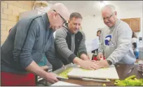  ??  ?? Jeff Fleak, Kevin Lobenberg and Kevin’s father, Dennis Lobenberg, prepare celery for a Waldorf salad as they help prepare for the Thankgivin­g meal at Grace & Mercy Charitable Foundation in Lodi on Wednesday morning.