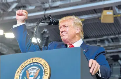  ?? AFP ?? Which hand has a coin?: US President Donald Trump speaks at a ‘Make America Great Again’ rally at Minges Coliseum in Greenville, North Carolina in July. /